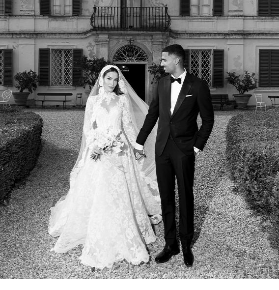 A couple at their wedding in a black and white photo