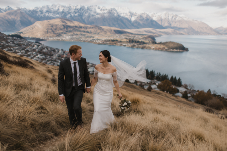 A couple at their ceremony almost kissing in front of the Queenstown lake