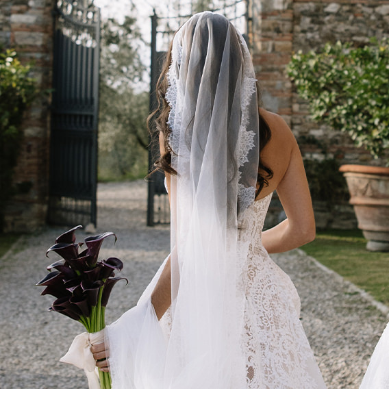 A bride facing away holding flowers