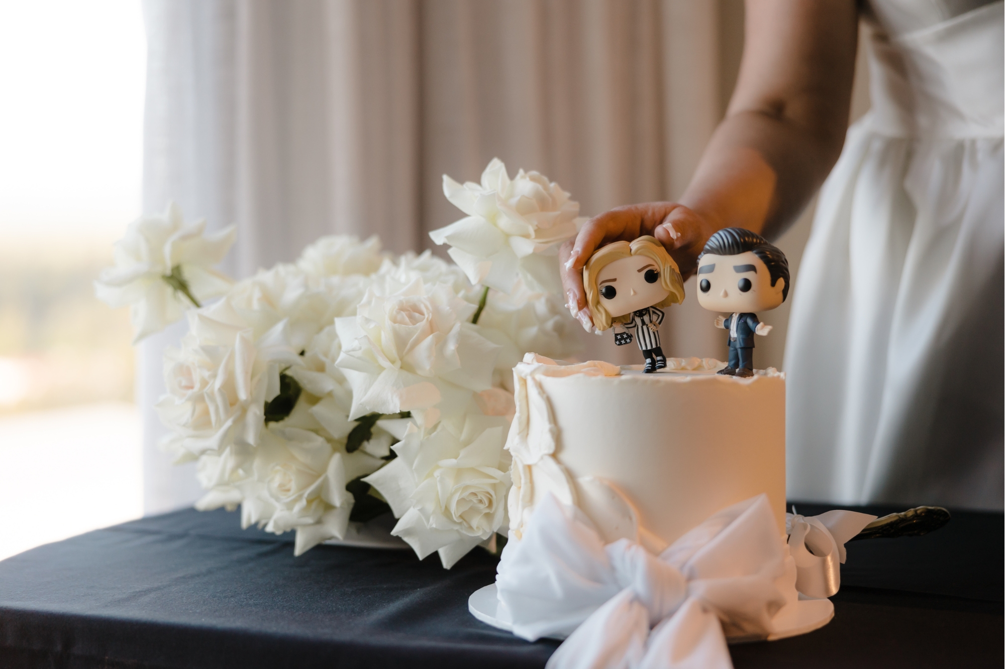 wedding cake with cartoon topper of couple