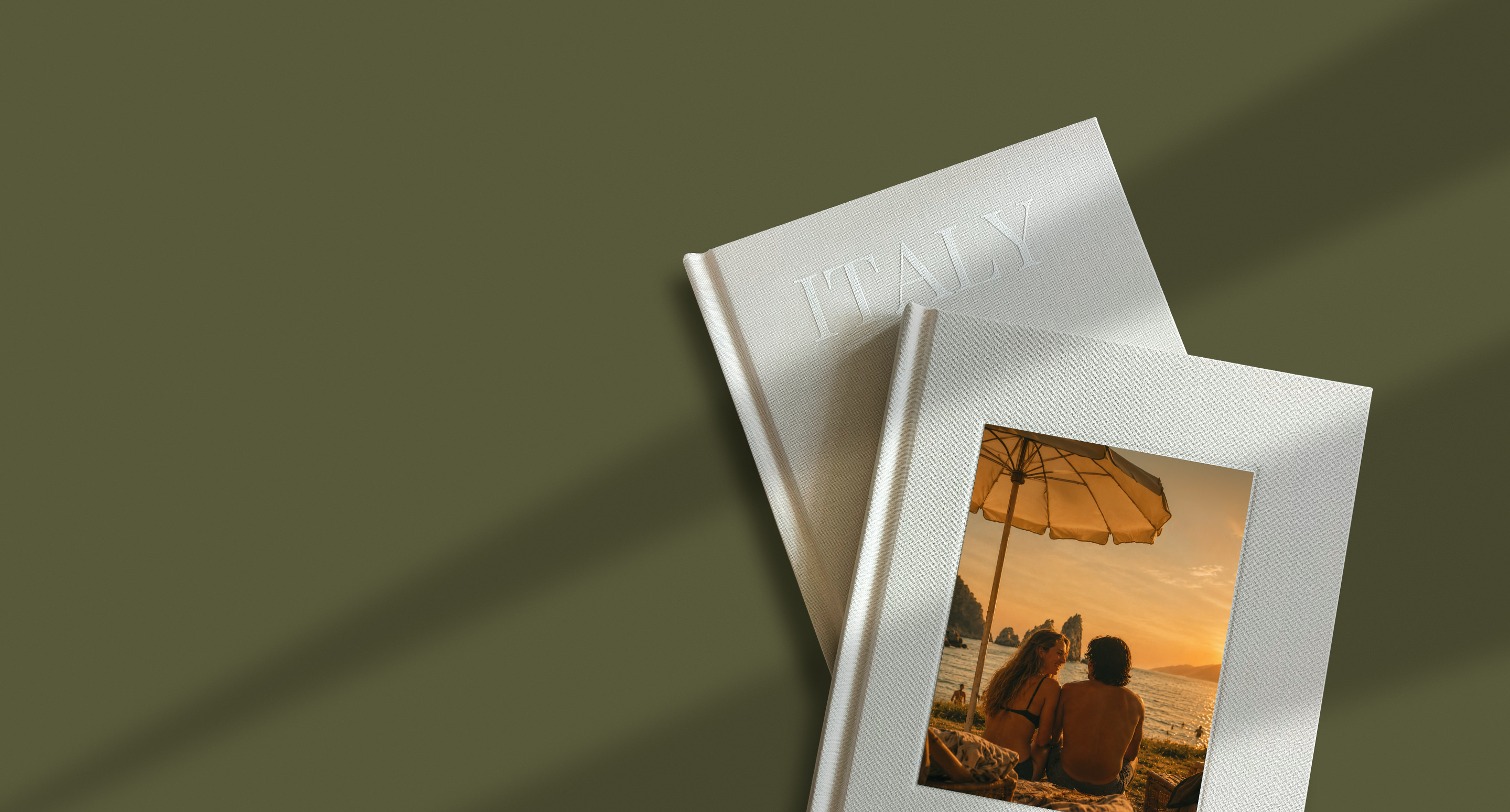 Two photo books on a green background