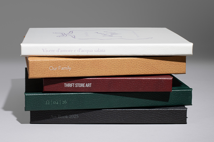 Stack of premium photo books with different vegan leather covers