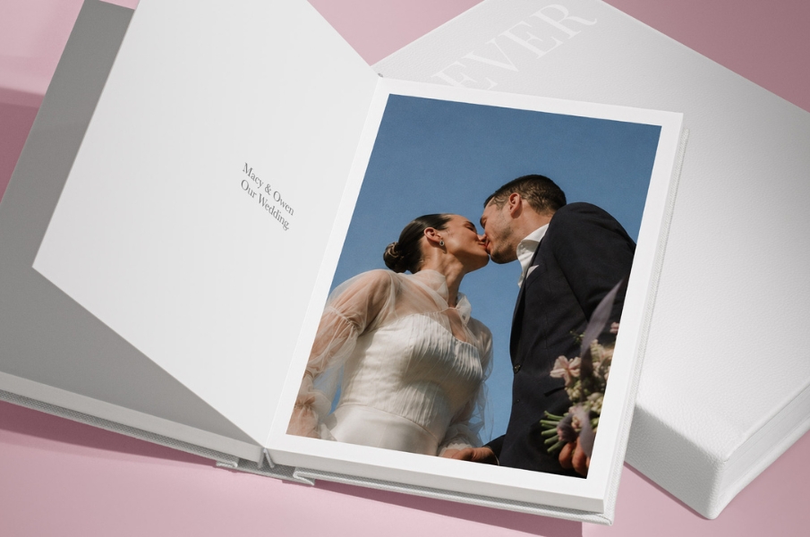 MILK square wedding album in black and white leather on beige background