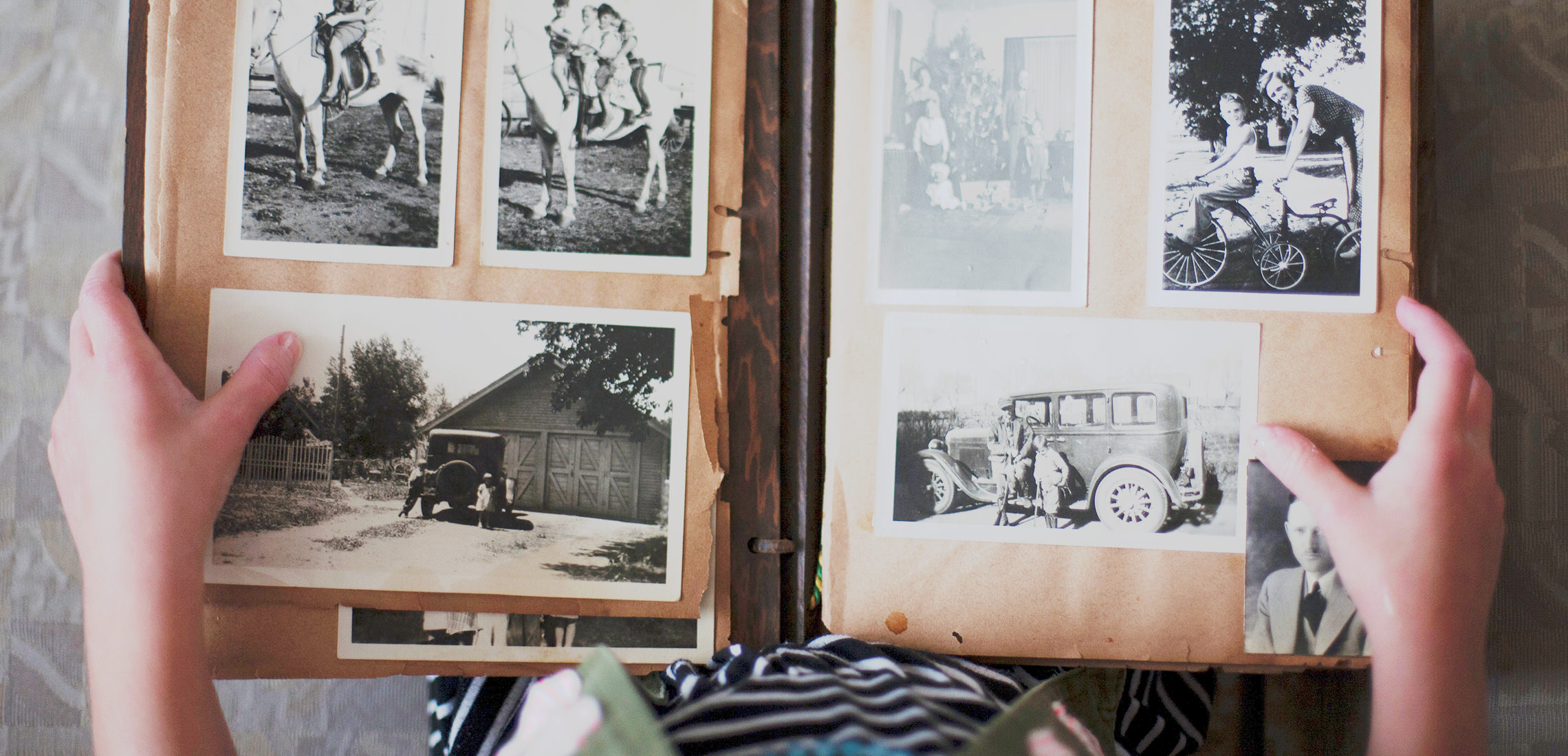 Birds eye view of a traditional photo album with black and white photos.